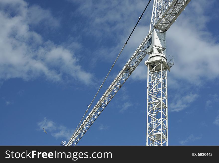 Detail of a lifting crane on sky background