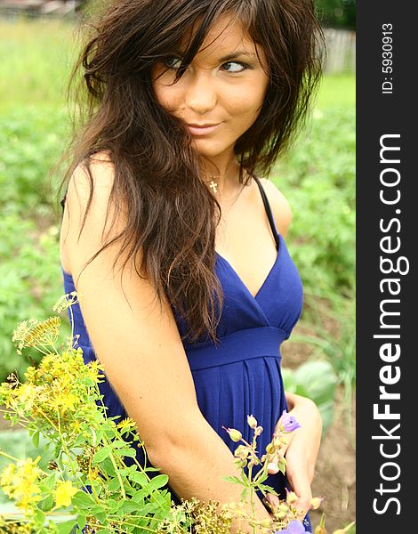 A girl with flowers in a blue dress