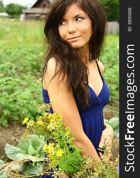 A girl with flowers in a blue dress