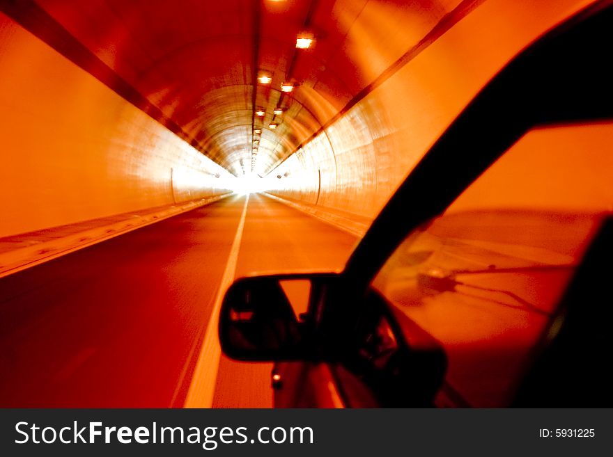 Car driving through a long tunnel with daylight at the end. Car driving through a long tunnel with daylight at the end