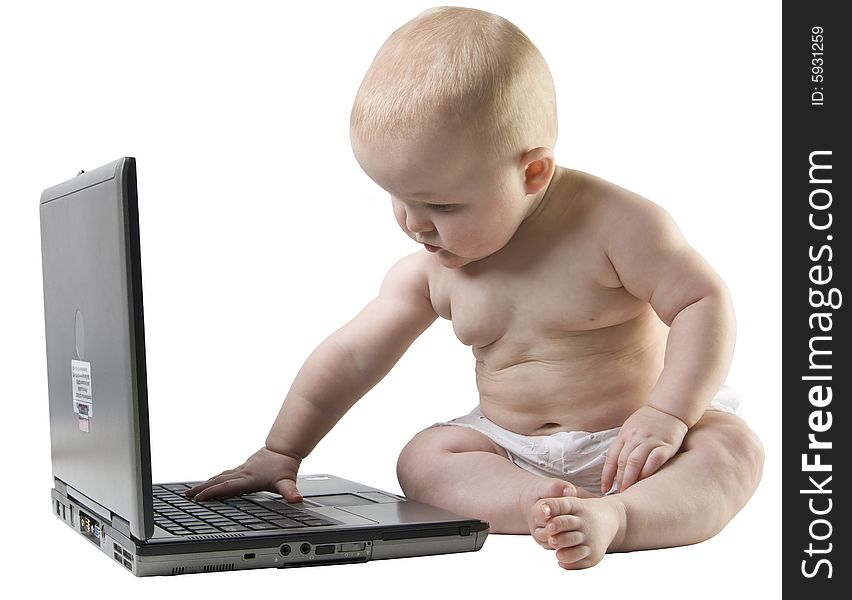 Baby appears to be typing something on a laptop. Baby appears to be typing something on a laptop.