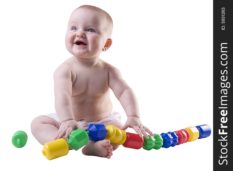 Baby holding large plastic beads in lap with smile on face. Baby holding large plastic beads in lap with smile on face.