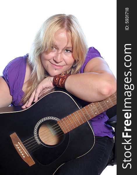 Woman rests head on arm which is on acoustic guitar. Woman rests head on arm which is on acoustic guitar