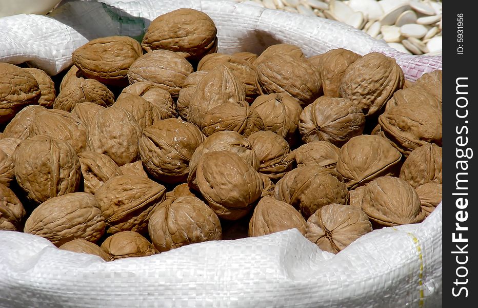 A bag of walnuts for sale at the market.