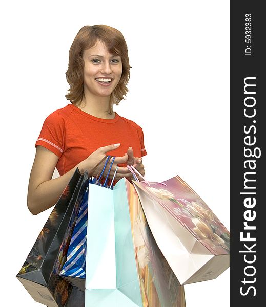 The girl in a red shirt with packages for purchases on a white background. The girl in a red shirt with packages for purchases on a white background.