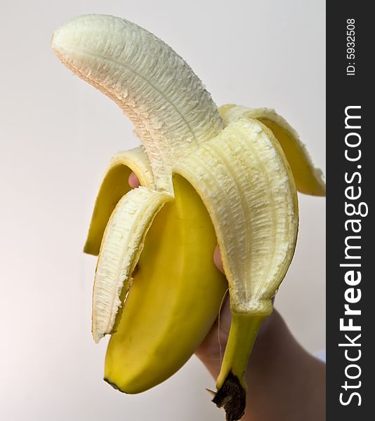 A held banana on white background.