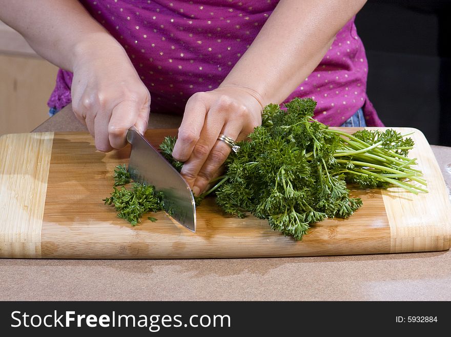 Woman Chopping Food In Kitchen