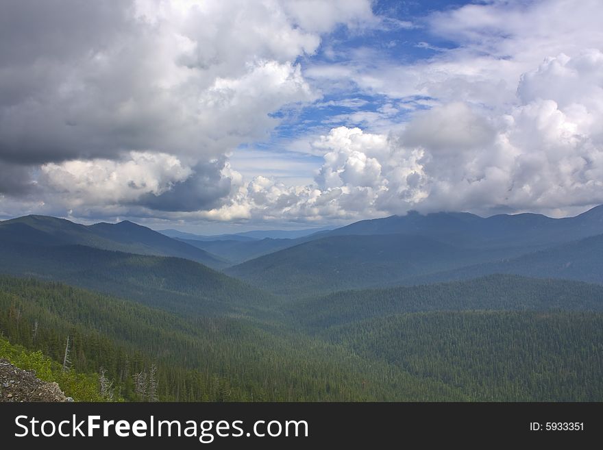 Mountains eyes of a bird. The fine sky and the infinite mountains disappearing in a blue fog. Beauty untouched the person of a nature.