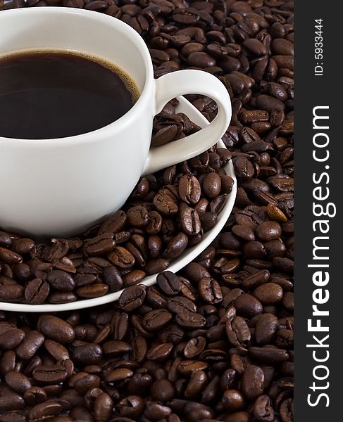 Coffee cup on coffee beans background