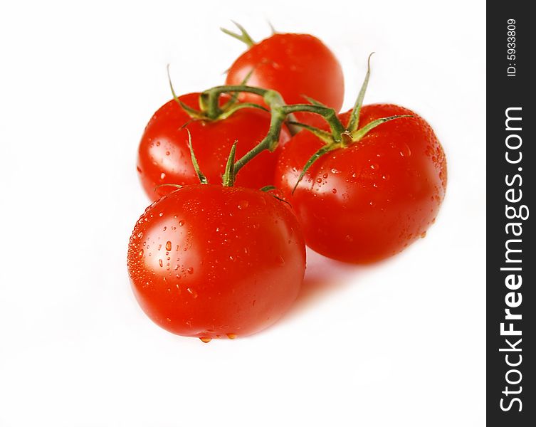 Cluster of red tomatoes isolated on white.