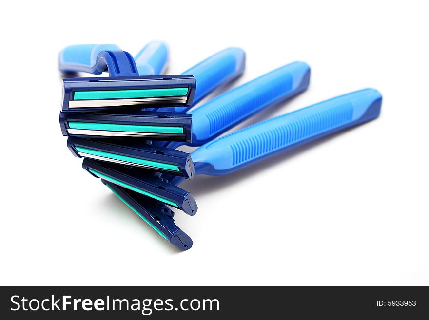 Many blue razor stacked together on white background. Many blue razor stacked together on white background.