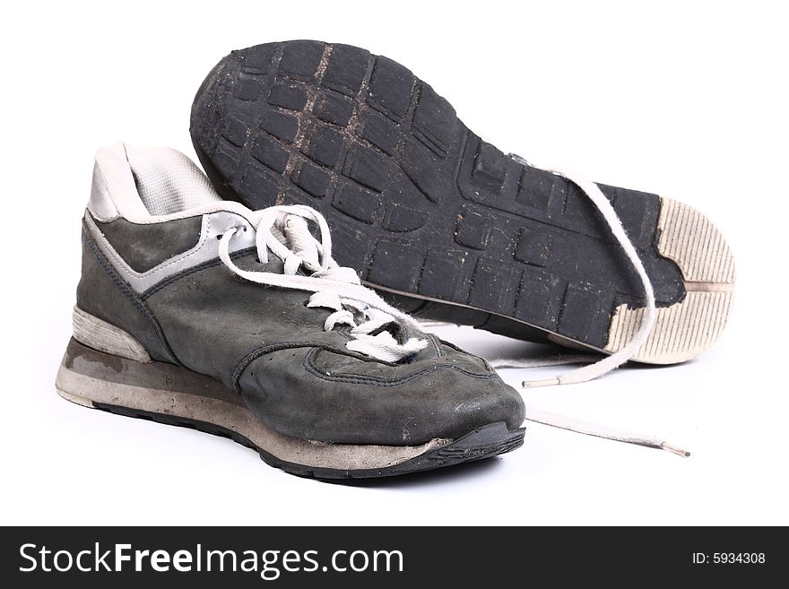 Old grungy Running Shoes isolated on white background