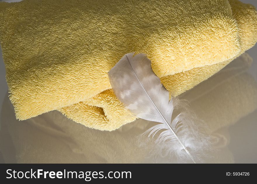 Two yellow towels with a feather. Two yellow towels with a feather.