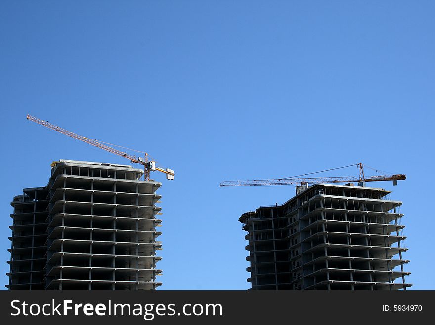Cranes on a building site of two buildings of hotel in the city of Odessa, Ukraine