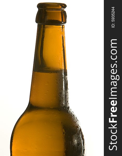 A brown beer bottle is filled with cool and fresh beer. A brown beer bottle is filled with cool and fresh beer.