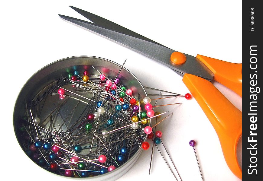 Multi-coloured pins and scissors