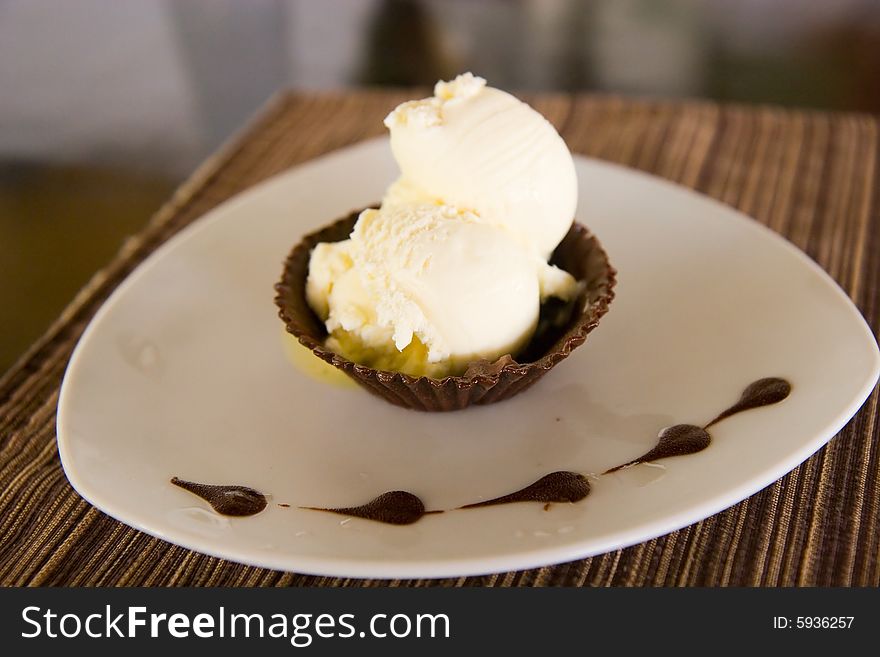 An delicious ice cream dessert with chocolate. An delicious ice cream dessert with chocolate