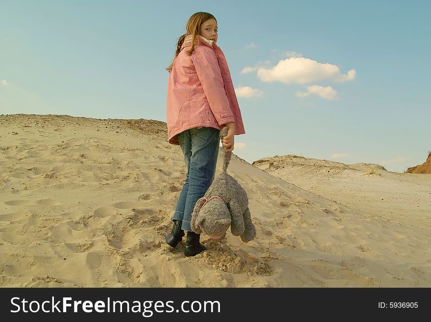 Girl with toy at sand