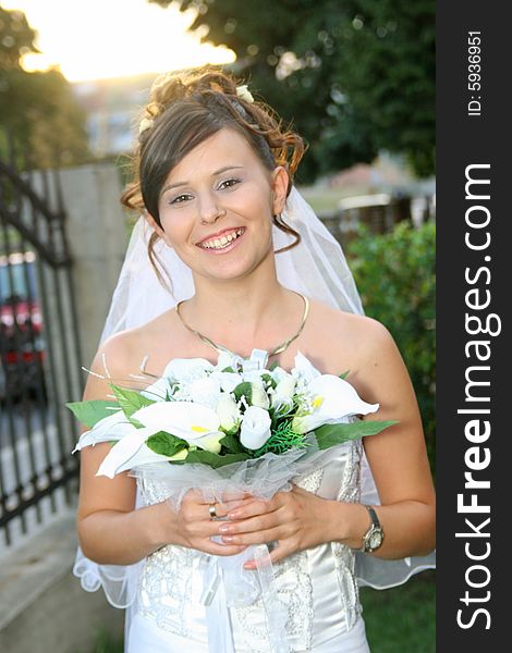 Beautiful happy bride standing outdoor. Beautiful happy bride standing outdoor