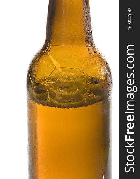 A brown beer bottle is filled with cool and fresh beer. A brown beer bottle is filled with cool and fresh beer.