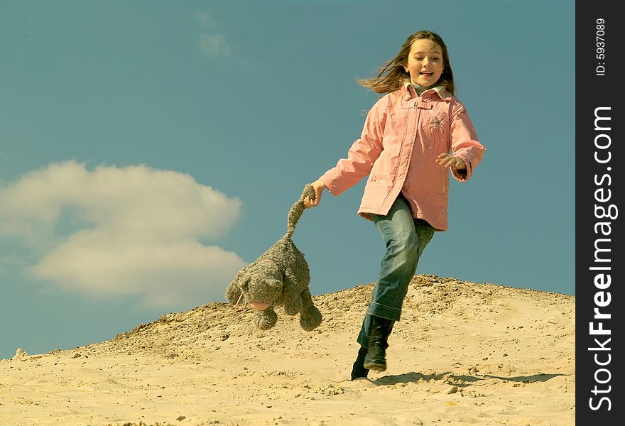 Louthing girl with toy at sand. Louthing girl with toy at sand