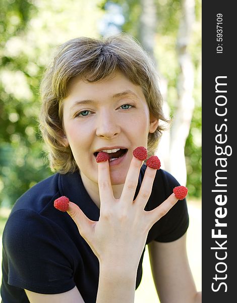 Woman with raspberries, shot outdoors