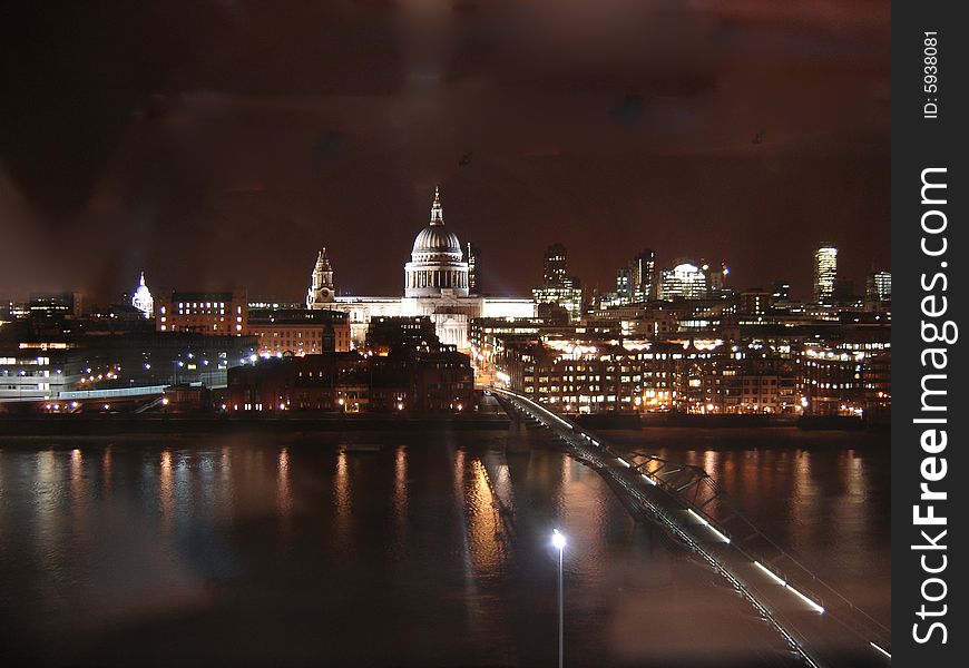 St Paul's Cathedral and the London Millennium Bridge, crossing the River Thames, at night. St Paul's Cathedral and the London Millennium Bridge, crossing the River Thames, at night.