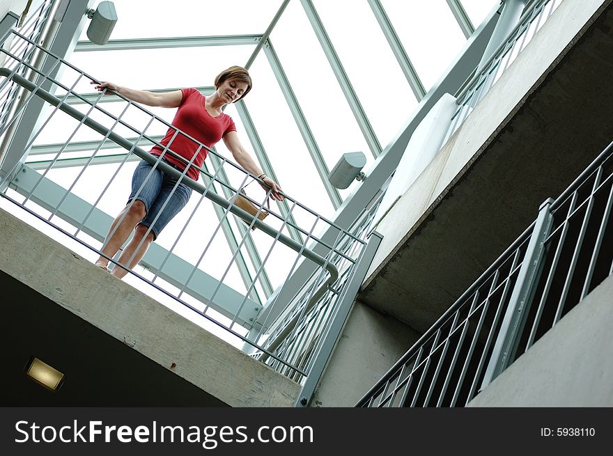 Woman standing on urban balcony looking around. Woman standing on urban balcony looking around.