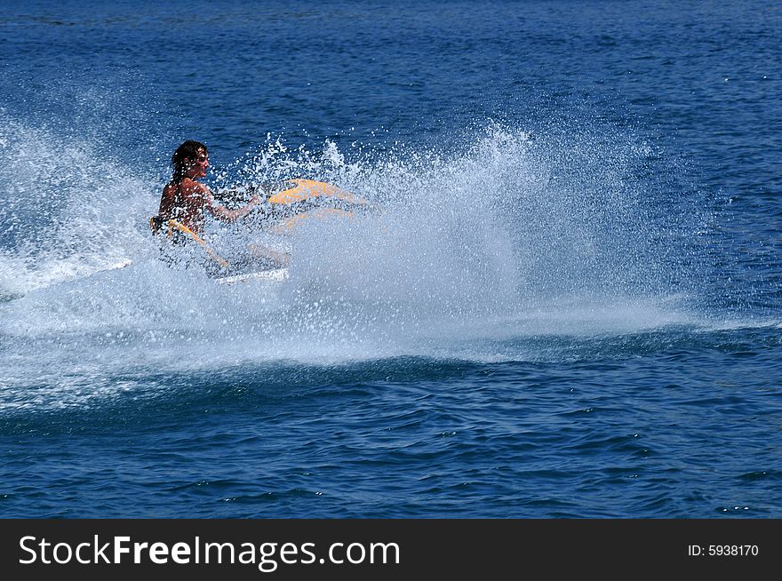 Boy on yellow jetski in the Adria near the island of Rab in Croatia. Boy on yellow jetski in the Adria near the island of Rab in Croatia