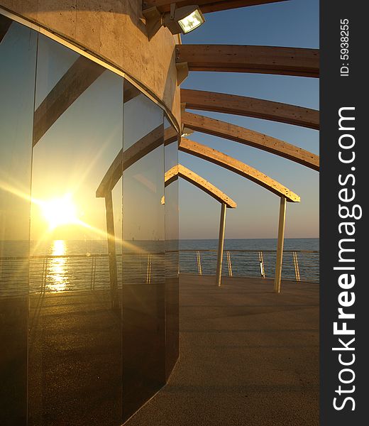 A beautiful shot of a dock at the sunset hour in Lido di Camaiore. A beautiful shot of a dock at the sunset hour in Lido di Camaiore