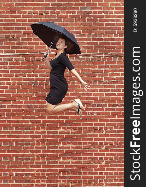 Lady jumping with umbrella high into air. Lady jumping with umbrella high into air.