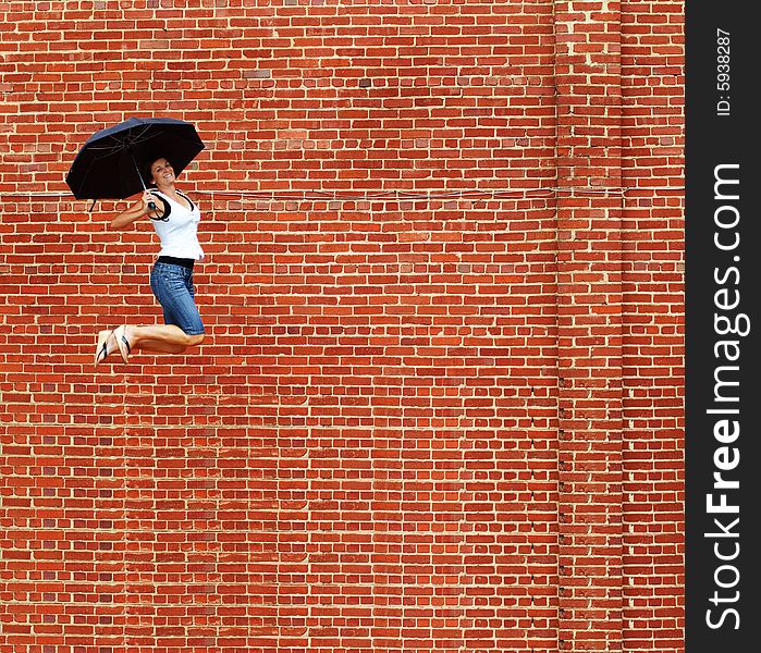 Lady jumping with umbrella high into air. Lady jumping with umbrella high into air.