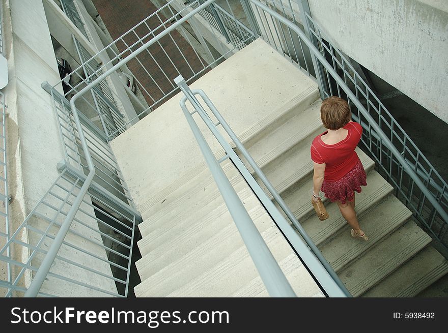 Urban woman walking up stairs.