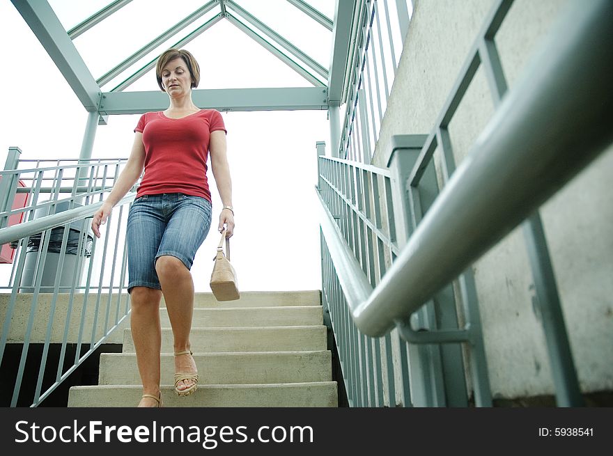 Urban woman walking up stairs.