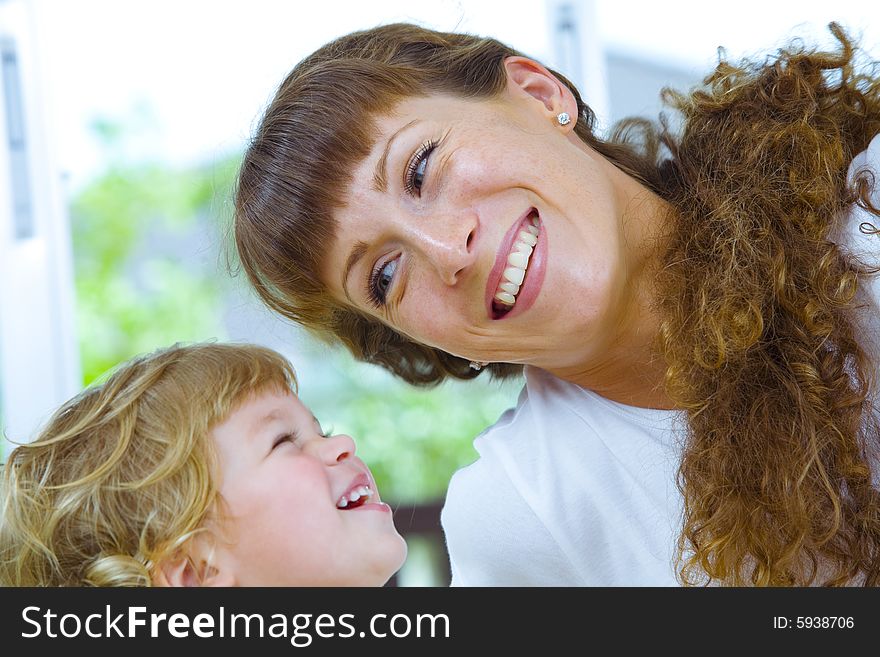 High key portrait of happy mother with baby. High key portrait of happy mother with baby