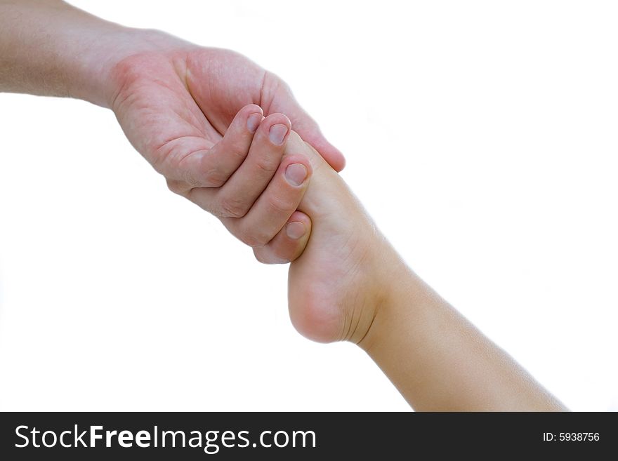 View of manâ€™s hand holding babyâ€™s toe on white background. View of manâ€™s hand holding babyâ€™s toe on white background