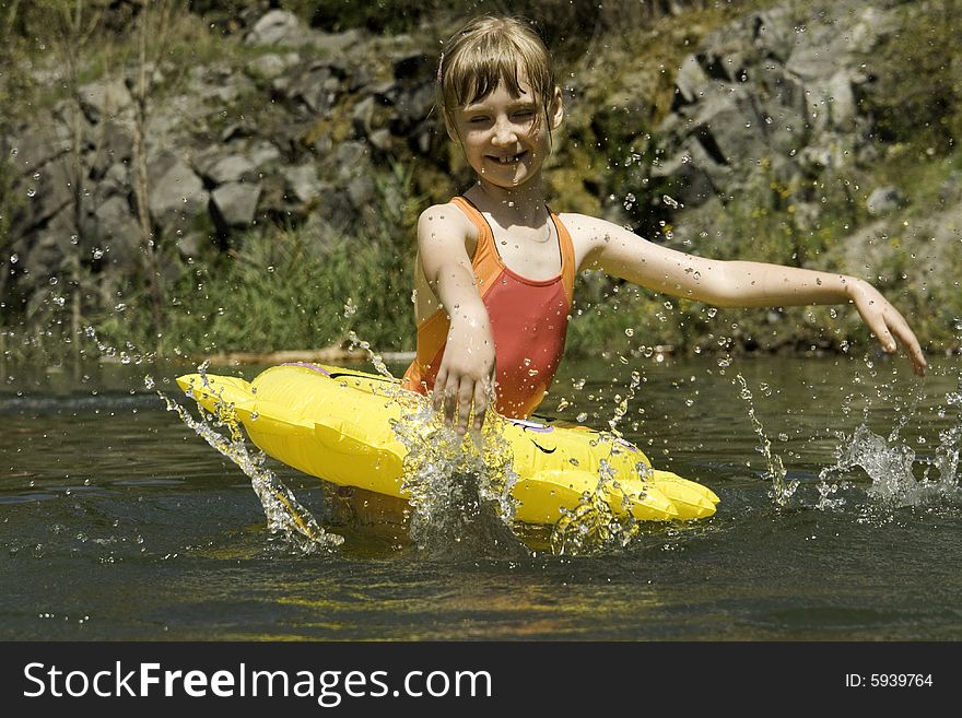 The girl floats on lake with a life buoy. The girl floats on lake with a life buoy