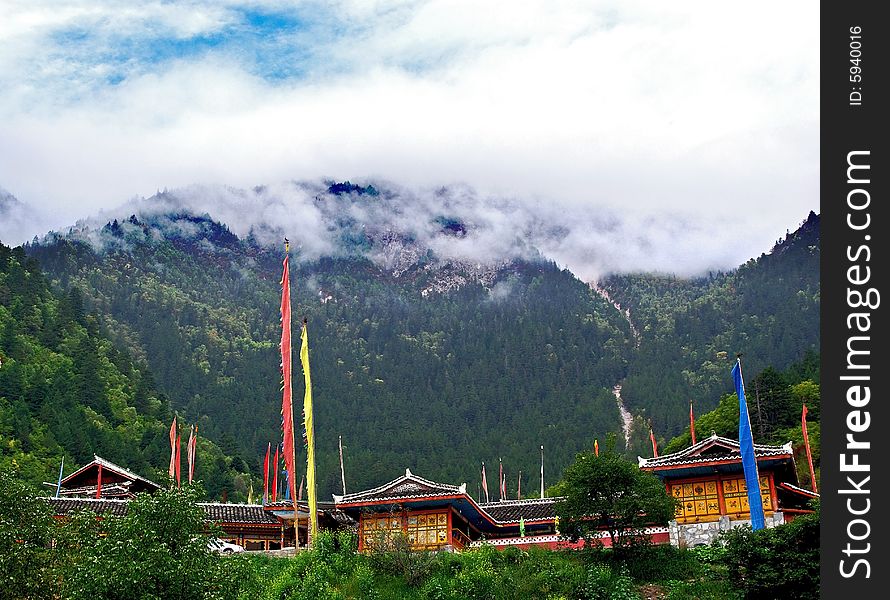 Tibetan village with mountian and clouds in background,Sichuan,china