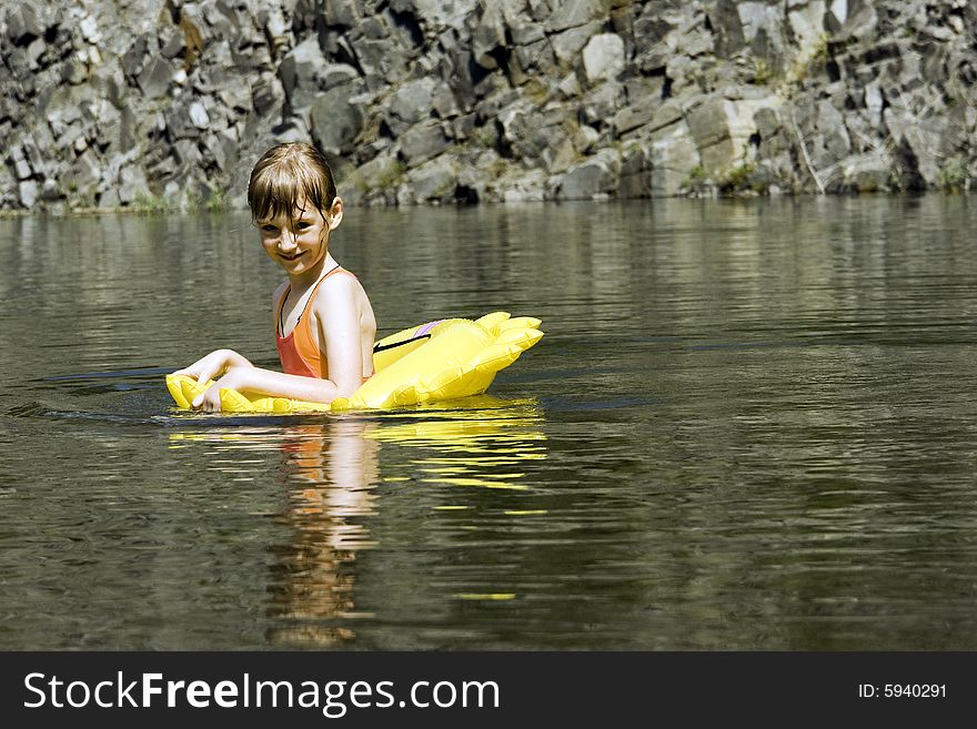 The girl floats on lake with a life buoy. The girl floats on lake with a life buoy