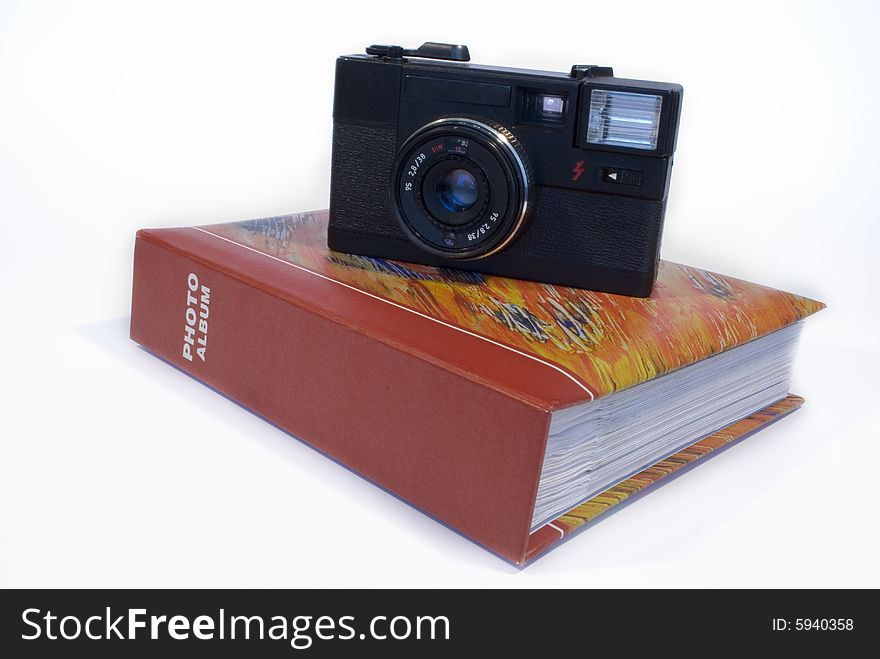 Film camera and photo album isolated on a white background