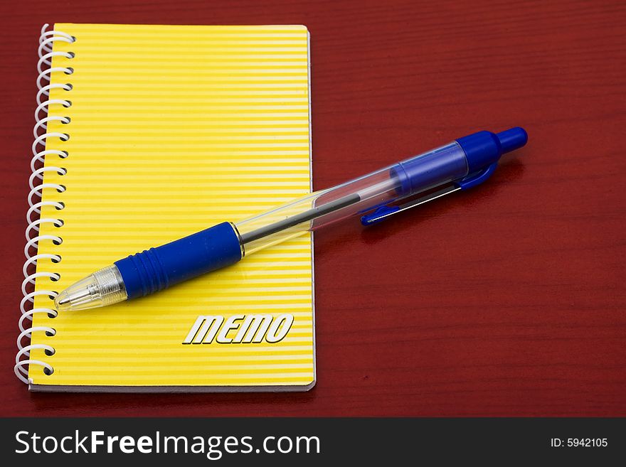 Bright yellow notepad and pen on table