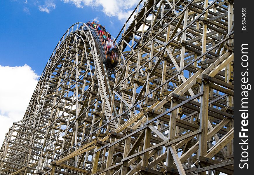 Photo of a wooden roller coaster in a theme park in the USA