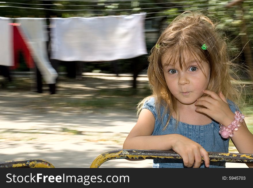 Little girl on the blured drying linen background. Little girl on the blured drying linen background