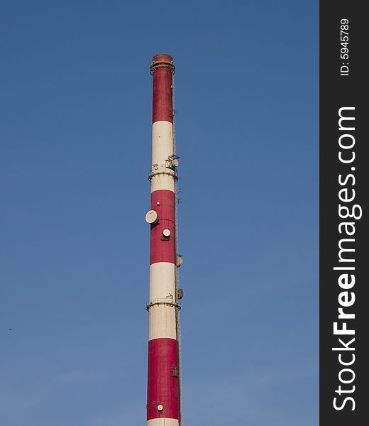 Tall chimney on a blue sky