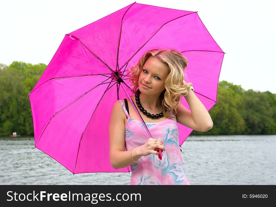 Beautiful girl with black necklace and umbrella