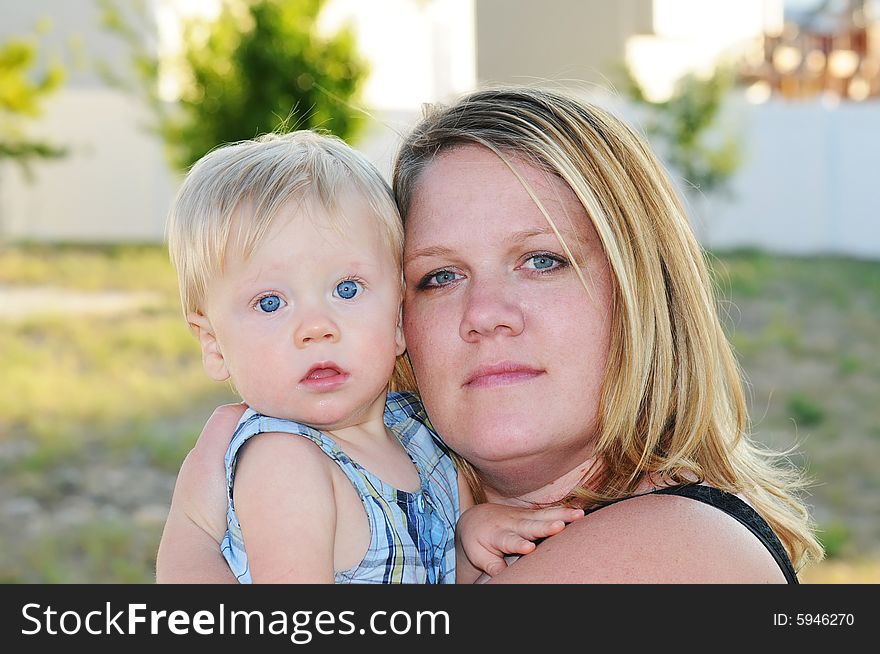 Mother holding her son towards the camera. Mother holding her son towards the camera