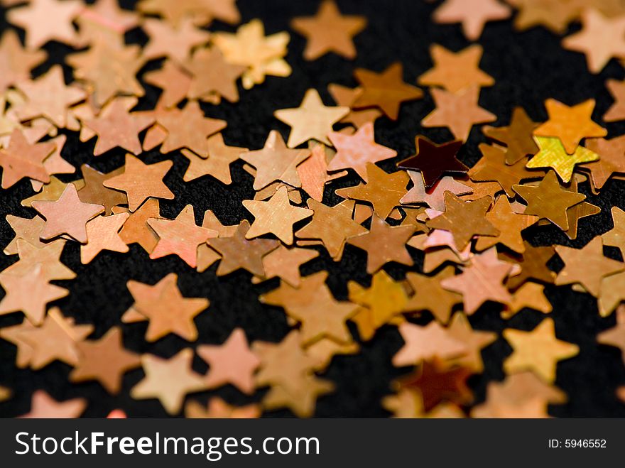 Golden christmas stars on black background