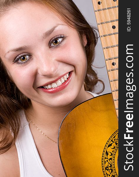 Close-up portrait of beautiful girl posing with guitar. #1