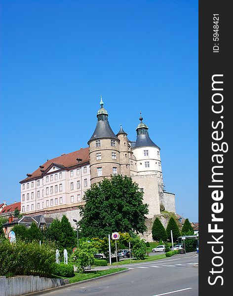 Castle with fountain on blue sky