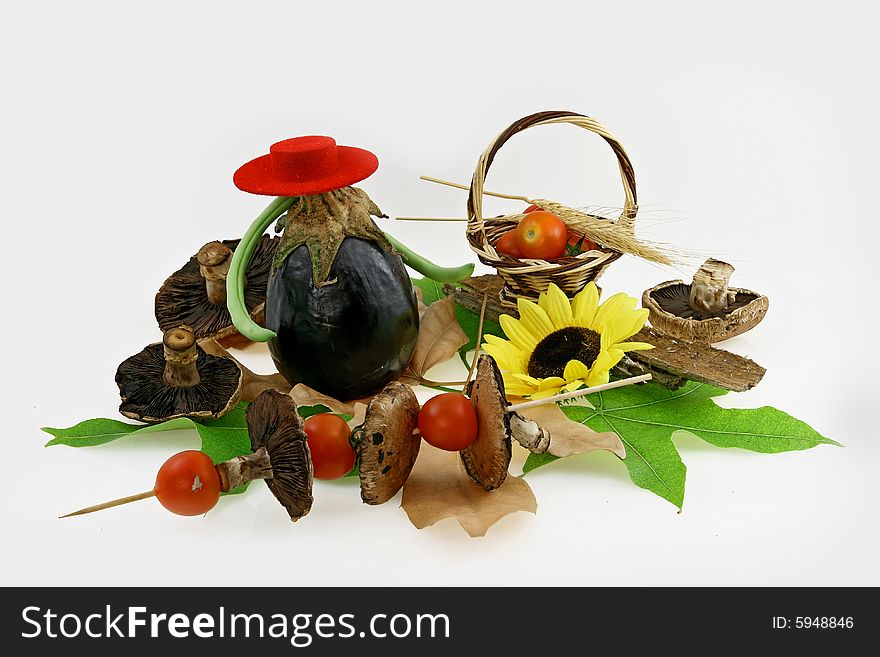 Composition from fresh mushrooms, tomatoes, sunflower on green leaves. Composition from fresh mushrooms, tomatoes, sunflower on green leaves